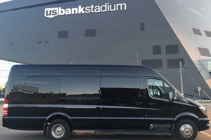 A black van parked in front of the us bank stadium.